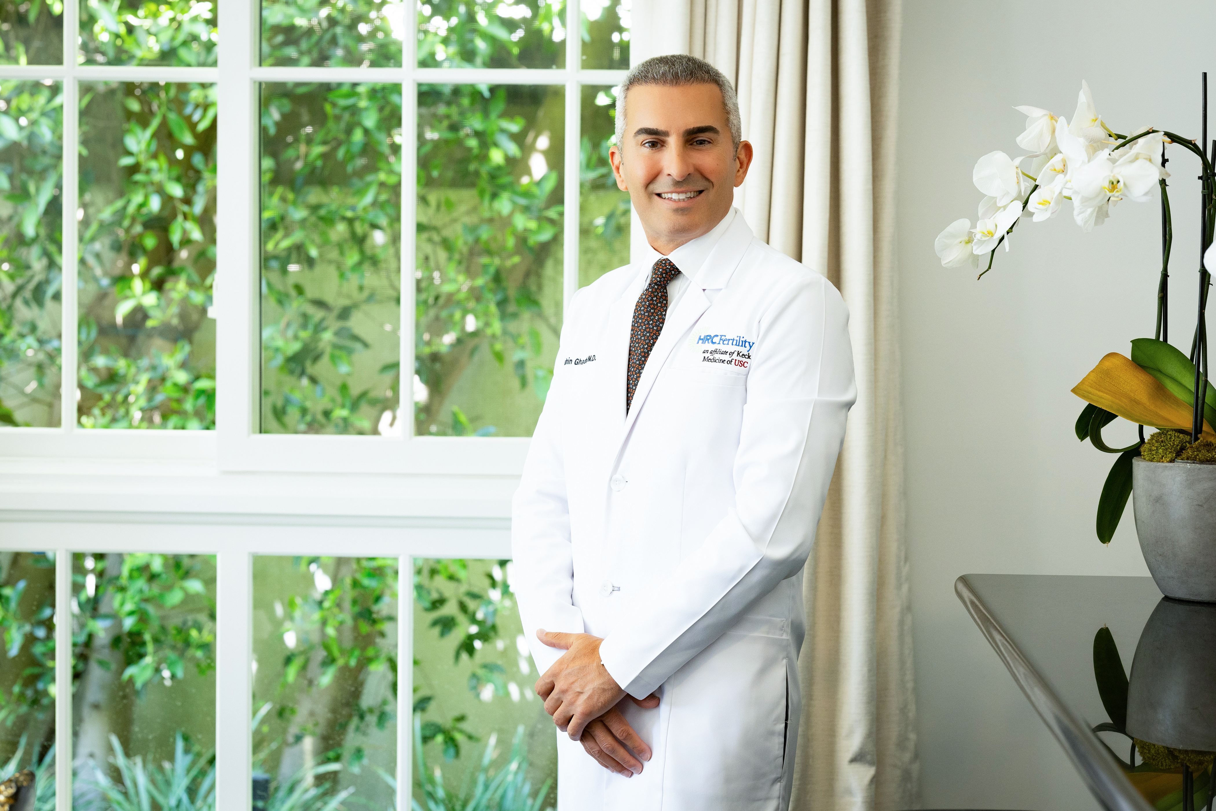 Editorial portrait of Dr. Shahin Ghadir in a sunlit clinic interior